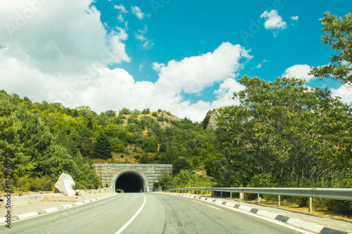 A picturesque landscape with a tunnel on a mountain road