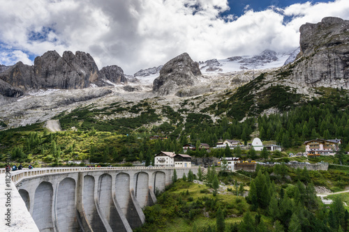 Fototapeta Naklejka Na Ścianę i Meble -  dam and reservoir at the foot of the Marmalade near the Fedaia Pass in the Dolomites in the Italian Alps