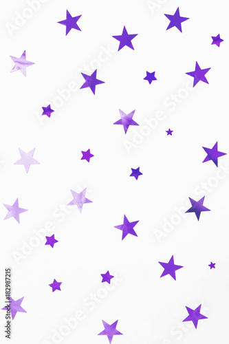 Holiday background with violet star confetti. Good background for Christmas and New Year cards.