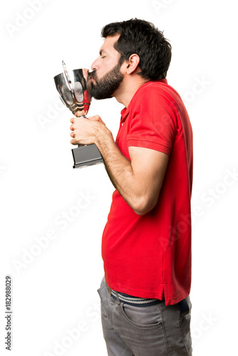 Handsome man holding a trophy