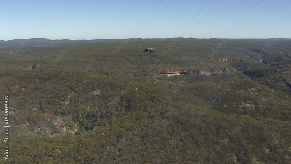 A full shot of a helictopter and trees with smoke. Camera moves forward A full shot of a helictopter and trees with smoke. Camera moves forward