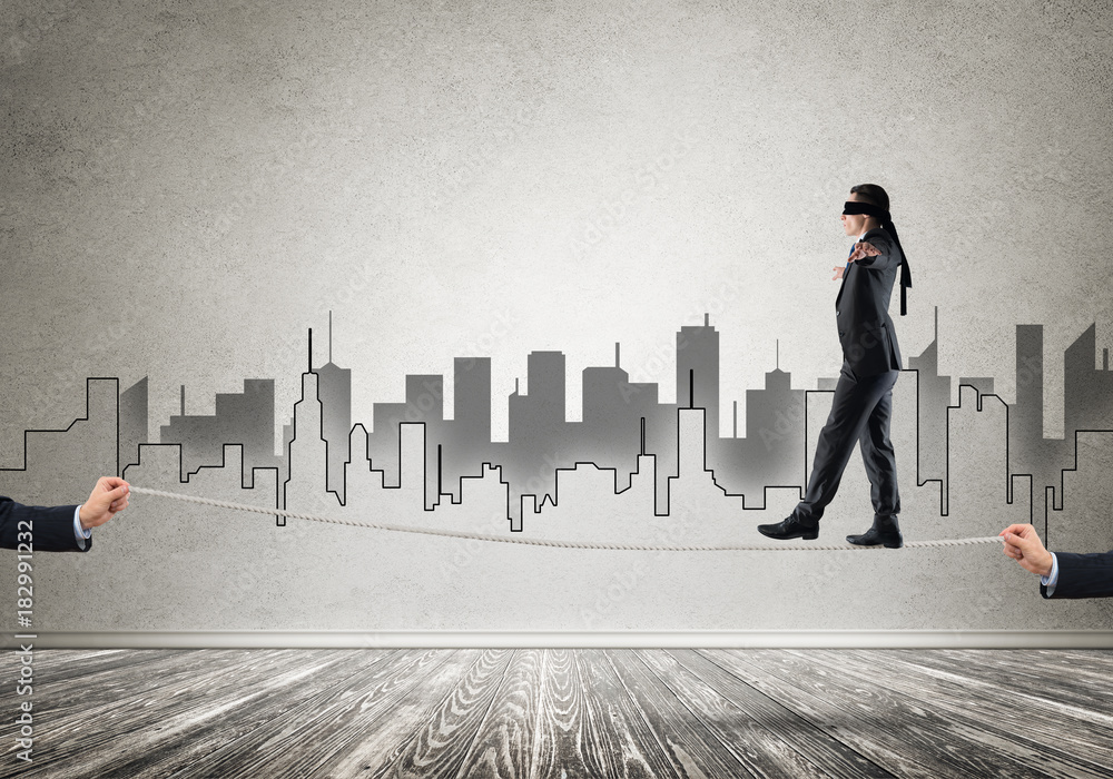 Business concept of risk support and assistance with man balancing on rope Business concept of risk support and assistance with man balancing on rope