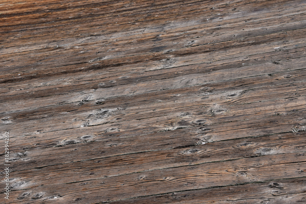 Fototapeta premium Aged worn timber boards from a pier - background texure