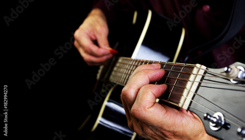 Playing an Acoustic Guitar. Closeup.