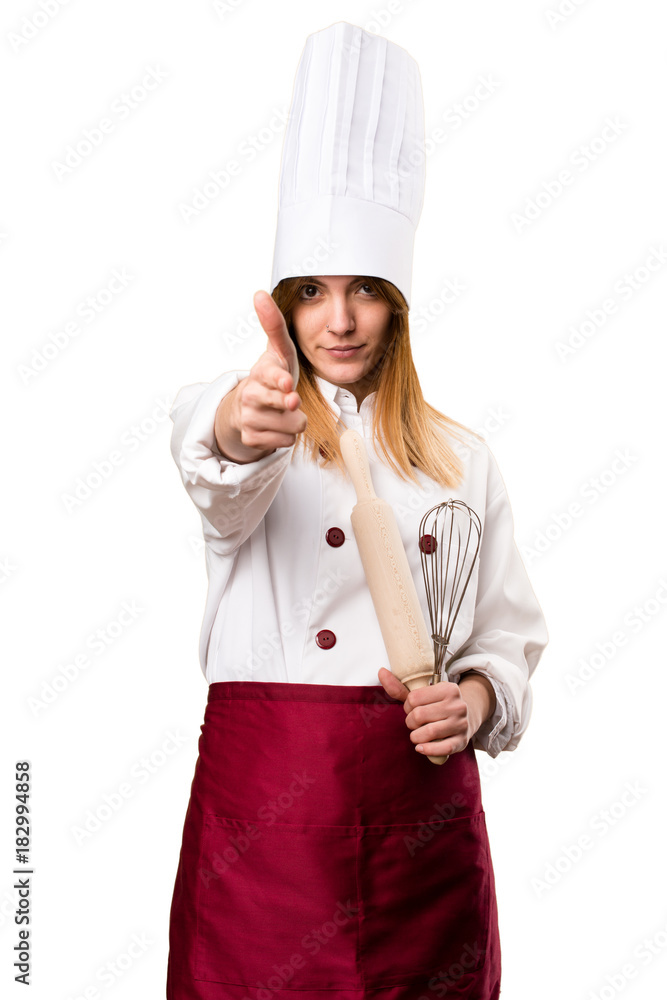 Beautiful chef woman making gun gesture