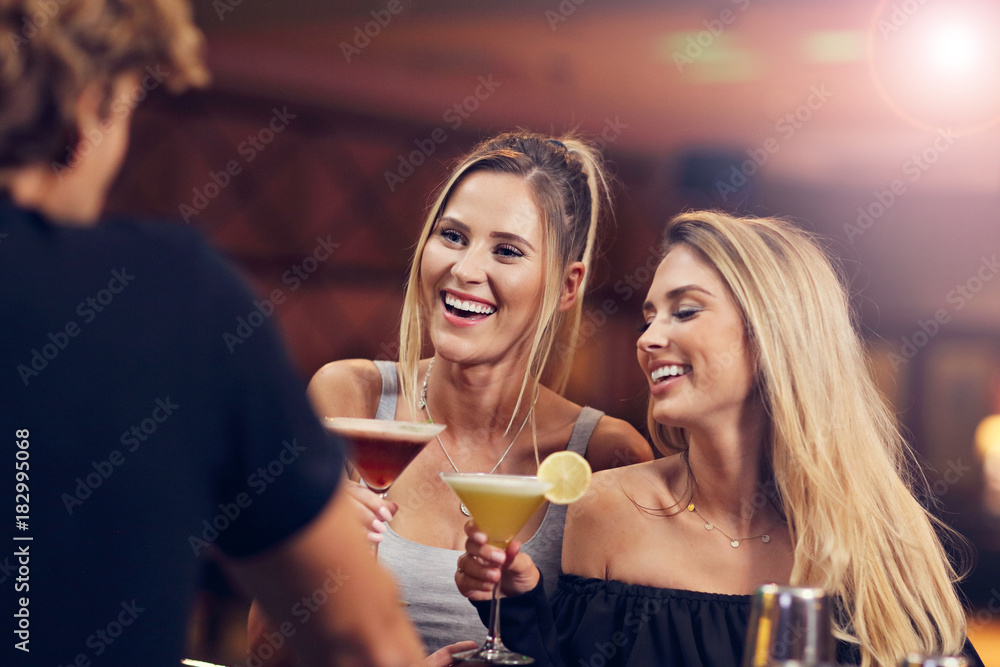 Group Of Friends Enjoying Drink in Bar Group Of Friends Enjoying Drink in Bar