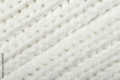 White knitted fabric texture. Hand knitting. Face side Interlacing of threads close up. Detailed warm yarn background.