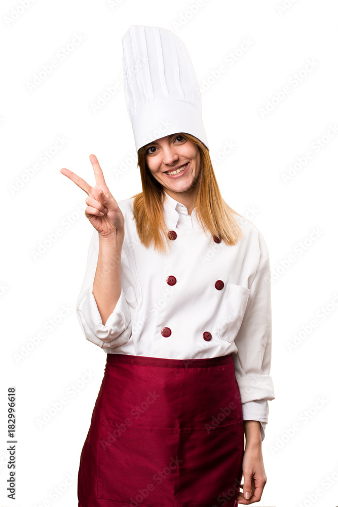 Beautiful chef woman making victory gesture Beautiful chef woman making victory gesture