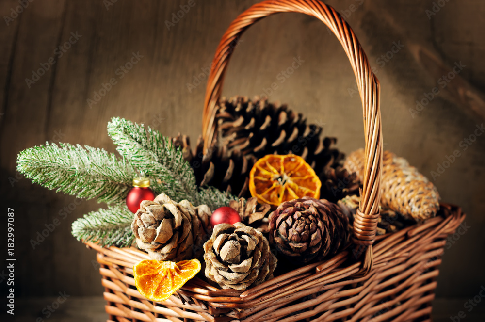 Wicker basket with pine cones and christmas decoration