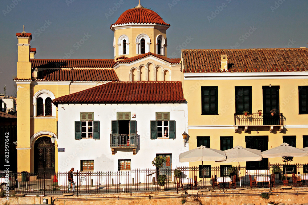 Greece, Athens, Plaka district, traditional houses with orthodox church in the background.