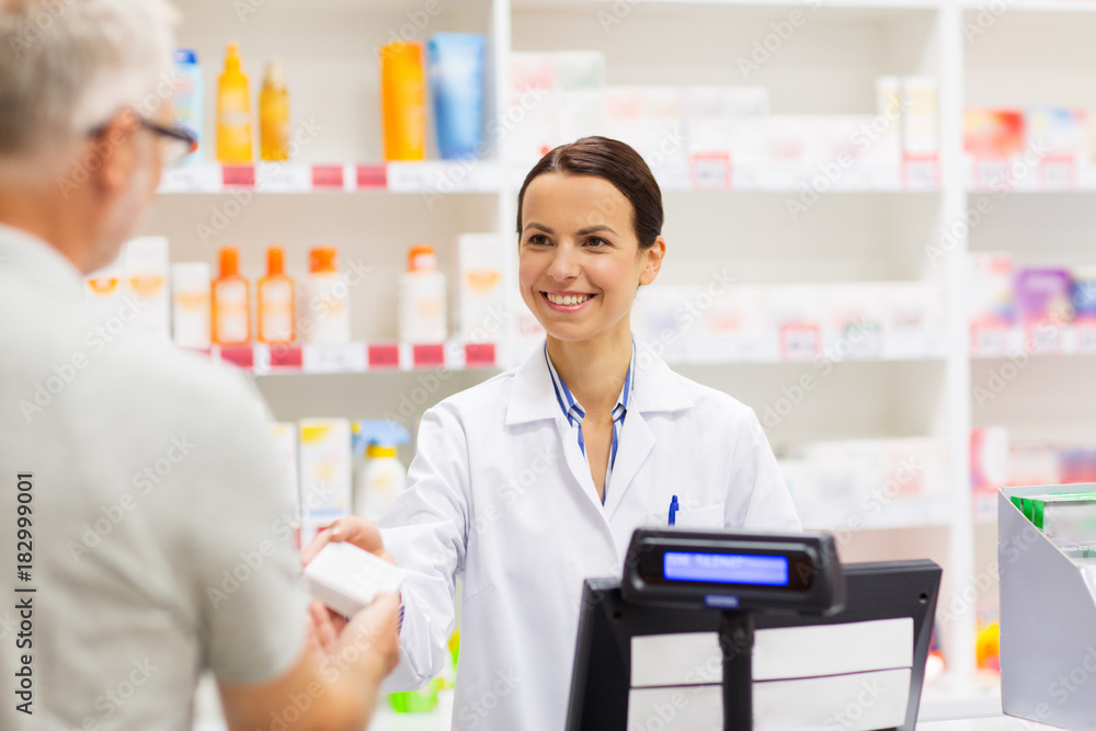 apothecary selling drug to senior man at pharmacy
