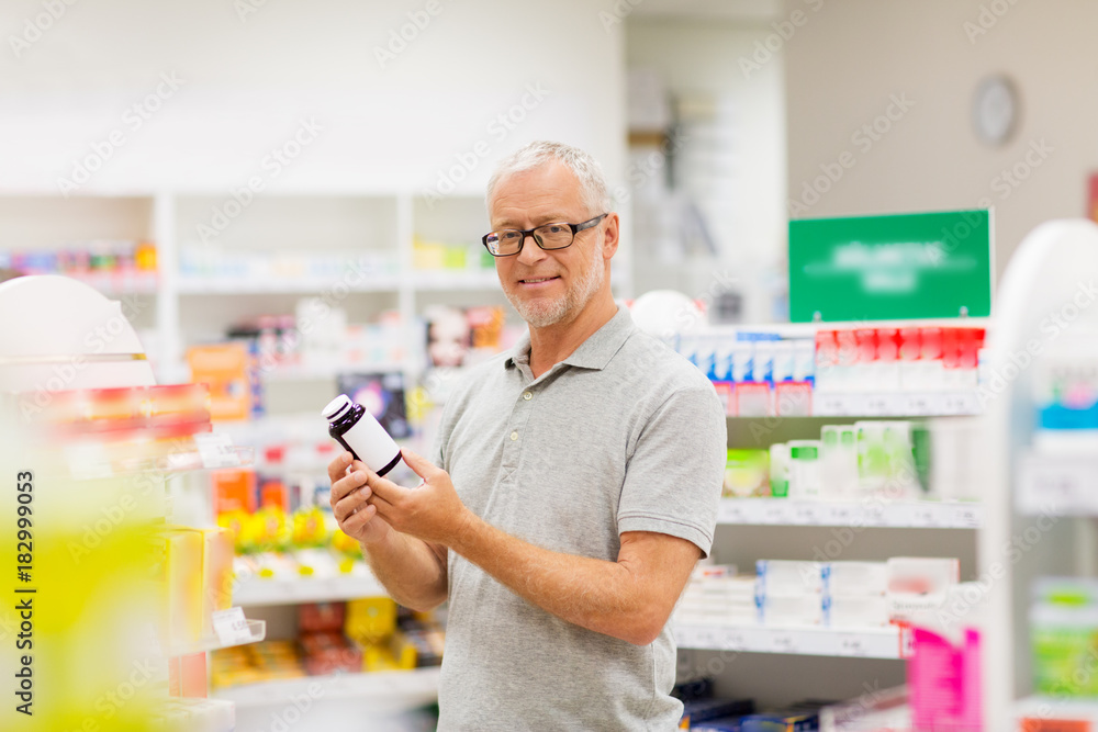 senior male customer with drug at pharmacy senior male customer with drug at pharmacy