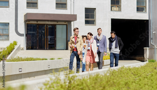 office workers with coffee walking in city