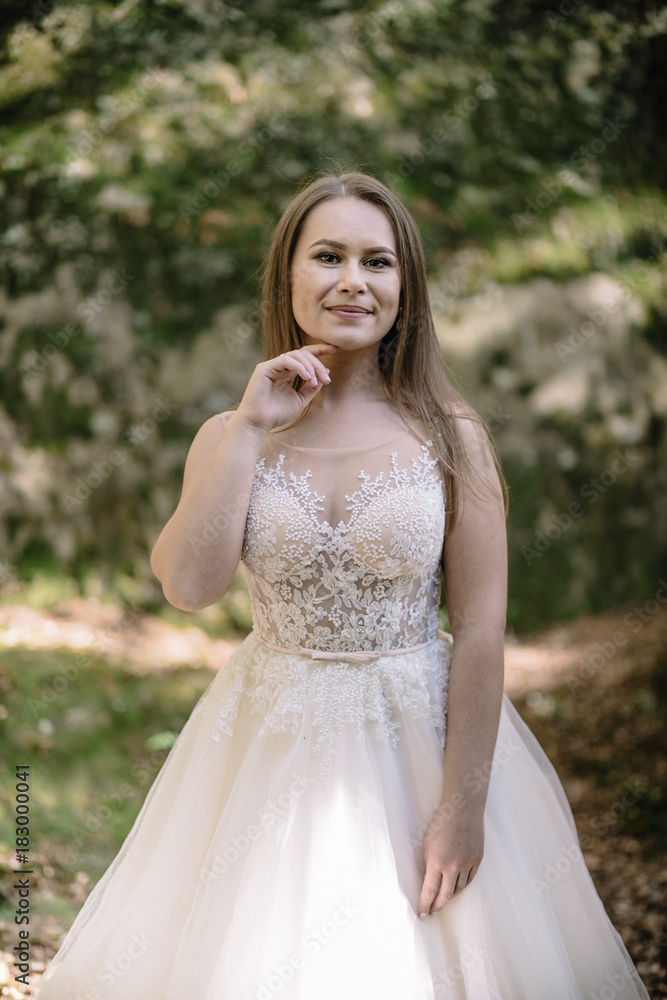 Beautiful stylish bride walking in the forest Beautiful stylish bride walking in the forest