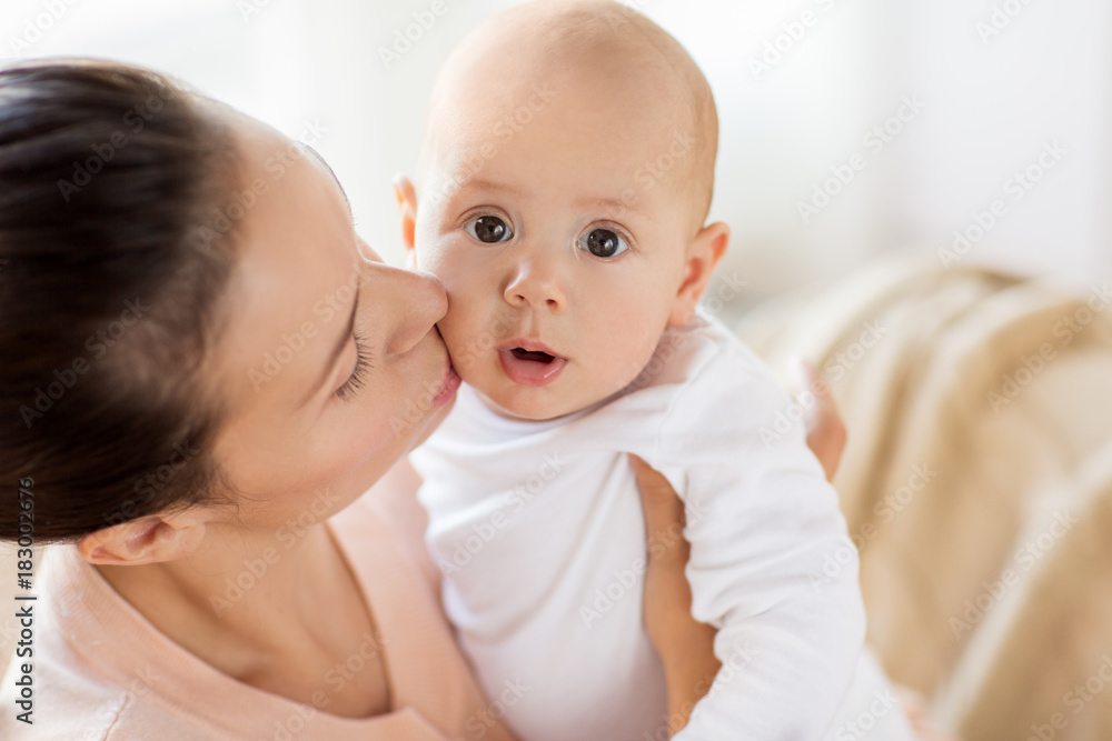 happy mother kissing little baby boy at home happy mother kissing little baby boy at home