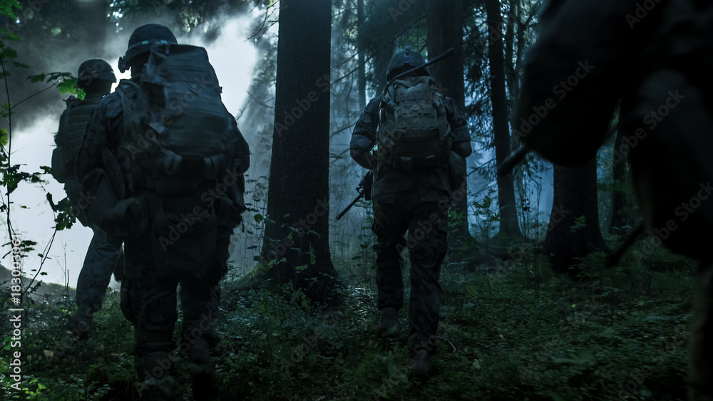 Fully Equipped Soldiers Wearing Camouflage Uniform Attacking Enemy, Rifles Ready to Shoot. Military Operation in Action, Squad Running in Formation Through Dark Dense Smokey Forest.