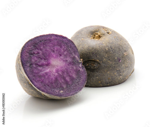 Vitelotte potato cut in half isolated on white background raw two purple halves. photo