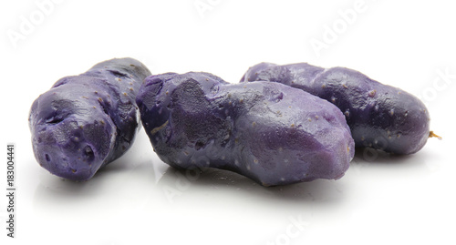 Boiled vitelotte potatoes isolated on white background three peeled purple. photo