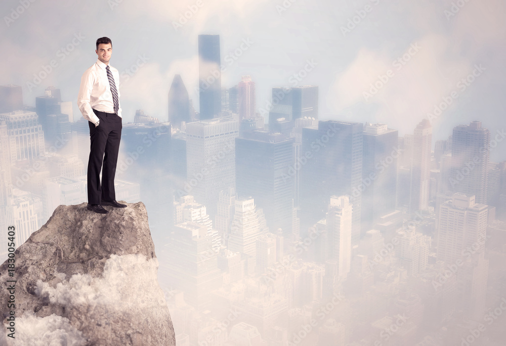 Winner urban businessman on top of stone Winner urban businessman on top of stone