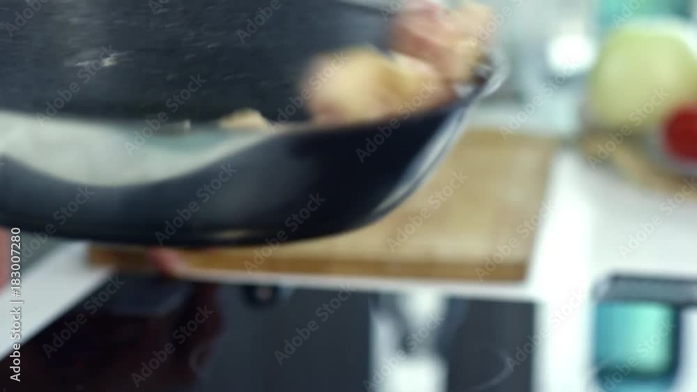 Close up of unrecognizable male cook tossing hot pan with chopped bacon sizzling in olive oil Close up of unrecognizable male cook tossing hot pan with chopped bacon sizzling in olive oil