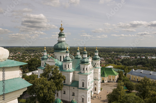Chernigov, Ukraine. August 15, 2017. Christian orthodox white church with green domes and gold crosses. View from high. Calm sky above