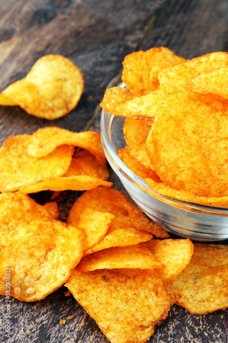 Crispy potato chips in a bowl. Tasty paprika chips.