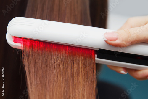 Keratin recovery hair and protein treatment pile with professional ultrasonic iron tool. Concept straighten hair