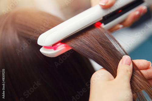 Keratin recovery hair and protein treatment pile with professional ultrasonic iron tool. Concept straighten hair