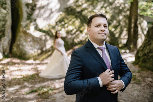 Young bride and groom walking high in mountains. Amazing weather with fog and sun © VAKSMANV