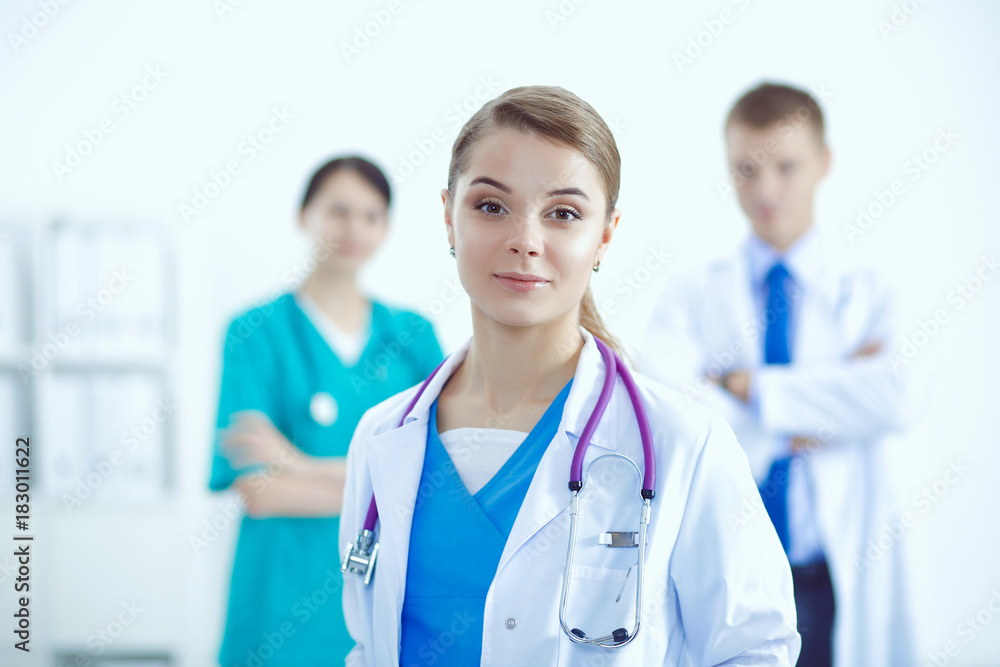 Attractive female doctor in front of medical group. Attractive female doctor in front of medical group.