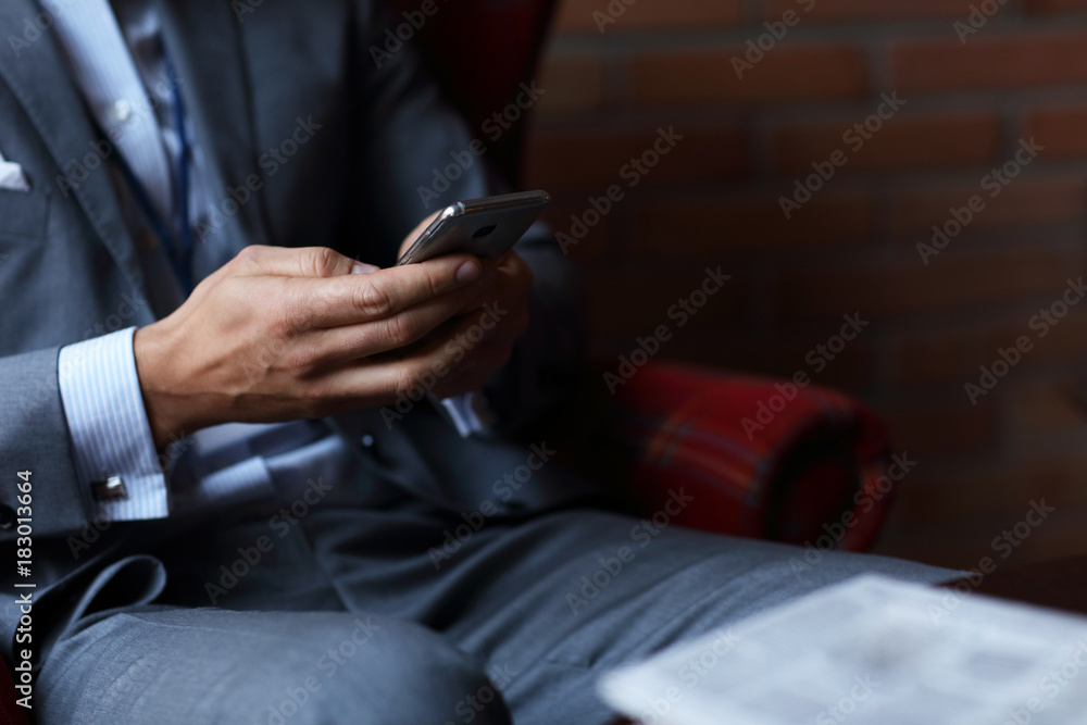 Young businessman texting on a smartphone Young businessman texting on a smartphone