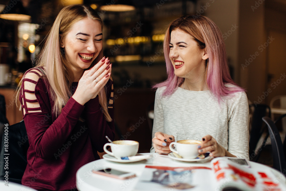 Two girls meat at coffee place and talk to each other, make conversation Two girls meat at coffee place and talk to each other, make conversation