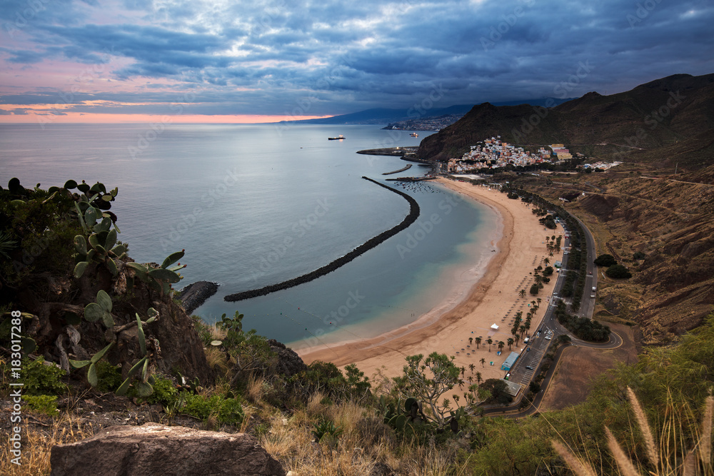 Coastline view of Playa de Las Teresitas beach, San Andres town and the capital city Santa Cruz de Tenerife in the background. The sand for this beach has been shipped from the Sahara desert