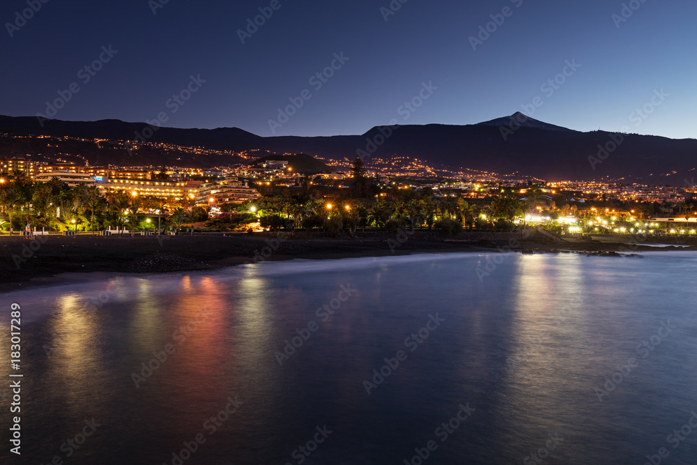 Scenic sunset view of Punta Brava down Playa Maria Jimenez beach with Pico del Teide volcano in the background, the highest point above sea level in the Canary Islands