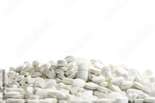A lot of white medicine pills on a white background