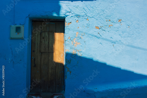 Door. Old wooden door. Juzcar village, Malaga province. Costa del Sol, Andalusia, Spain. © Ekaterina