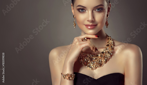 Beautiful girl with set jewelry .   Woman in a necklace with a ring, earrings and a bracelet. Beauty and accessories.
