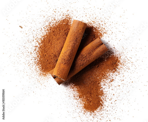 Leinwand Poster cinnamon sticks with powder isolated on white background