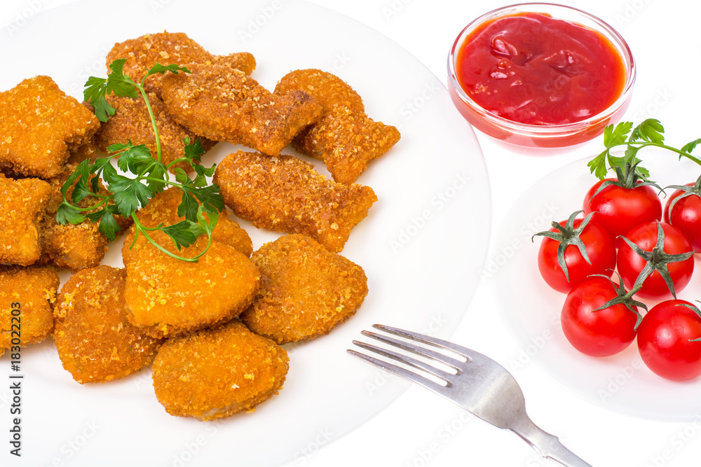Nuggets of different shapes with ketchup on white background