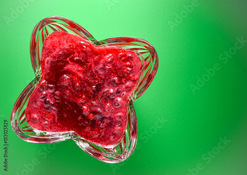 Overhead view of homemade holiday cranberry sauces in crystal serving dish.   Green screen background and copy space.