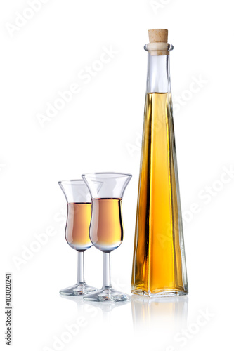 Glas and bottle of liqueur, isolated 
