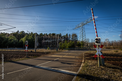 Fotografie Colorful sunset on double track level crossing