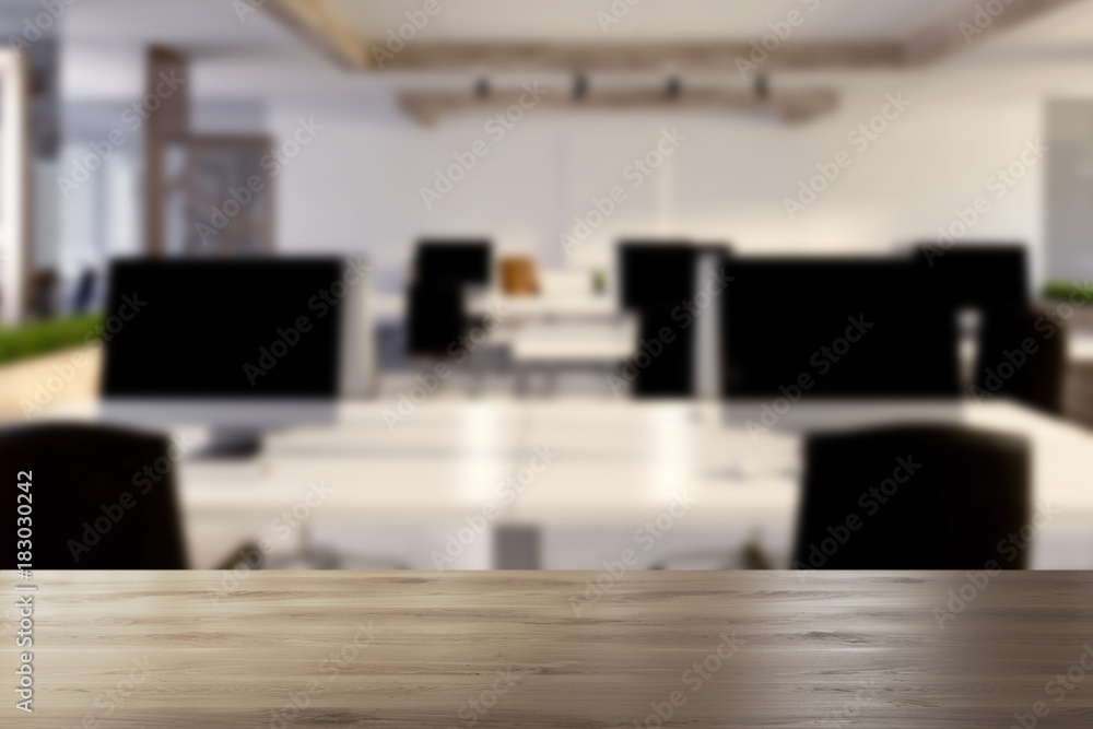 Computers on wooden office desks blurred Computers on wooden office desks blurred