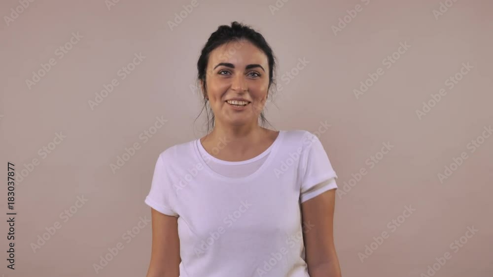 happy beautiful caucasian woman with black hair have fun showing a tongue . Portrait young girl wearing casual white t-shirt happy beautiful caucasian woman with black hair have fun showing a tongue . Portrait young girl wearing casual white t-shirt