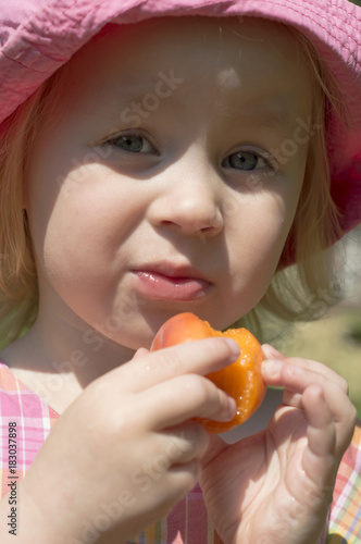portrait of adorable laughing little girl in a warm spring day