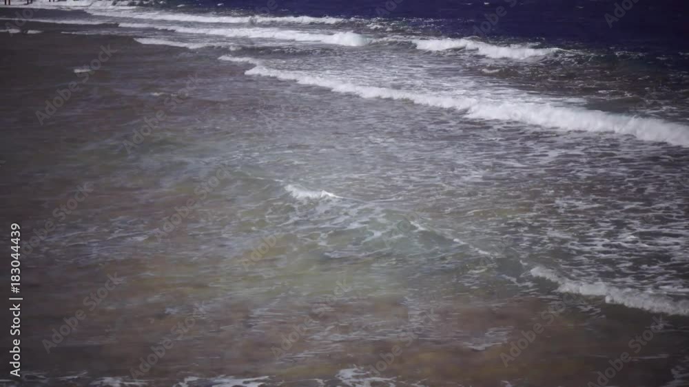 Blue ocean is stormy from the wind, waves are beating against the shore Blue ocean is stormy from the wind, waves are beating against the shore