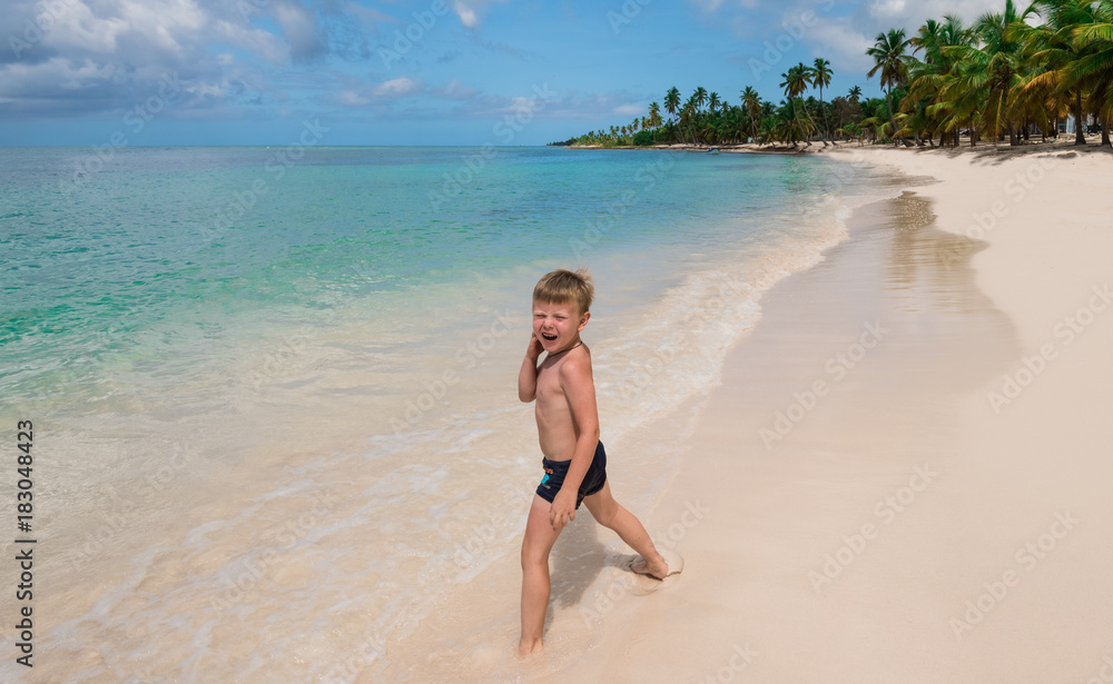 one little boy on a tropical beach