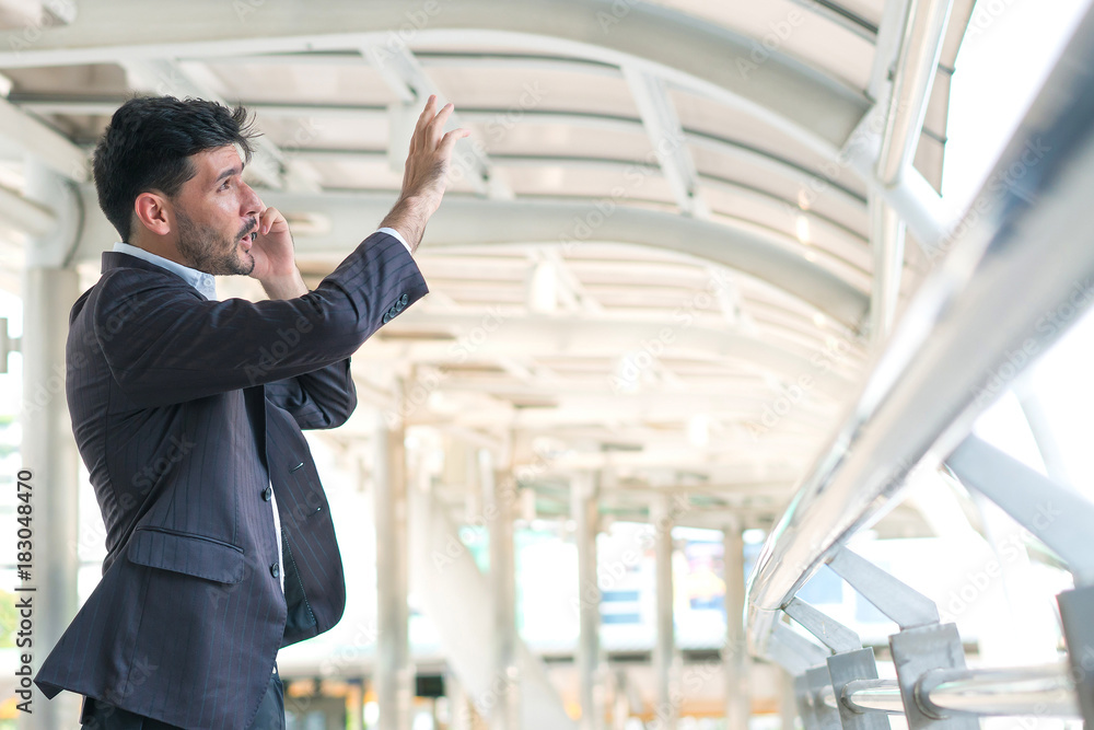 Business man talking smartphone at outdoors. Concept of business professional and consult. Business man talking smartphone at outdoors. Concept of business professional and consult.