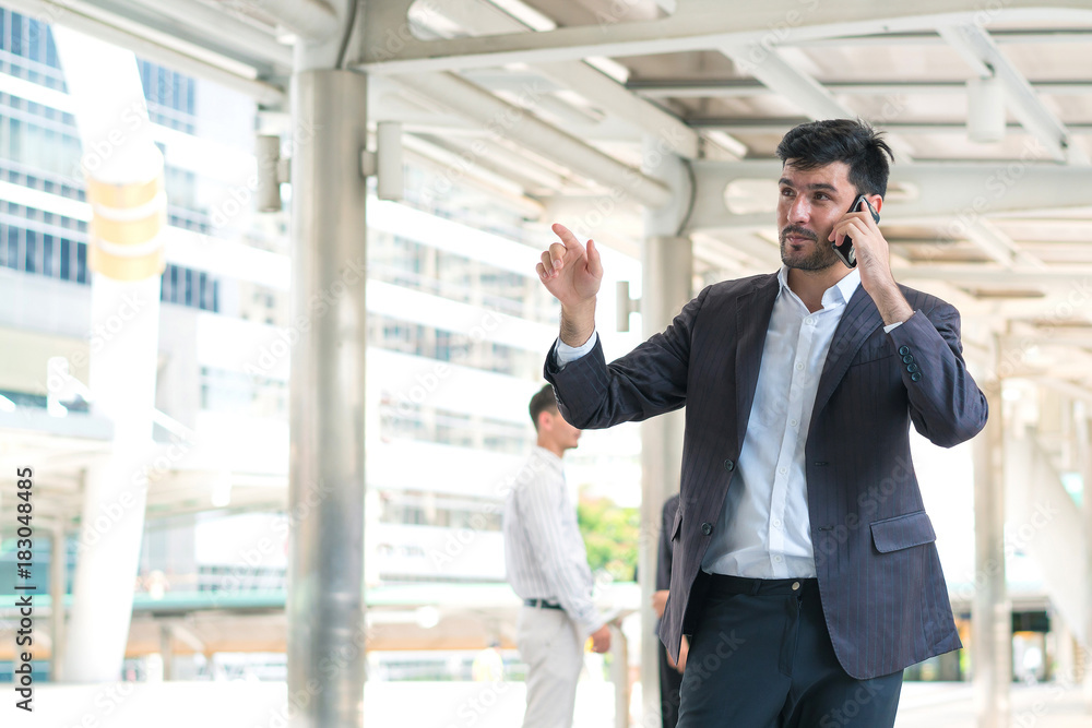 Business man talking smartphone at outdoors. Concept of business professional and consult. Business man talking smartphone at outdoors. Concept of business professional and consult.