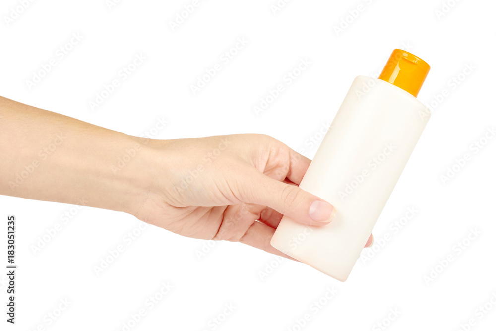 Plastic white shampoo bottle with orange cap in hand isolated on white background. Gel dispenser for hair care. Container with body lotion. Plastic white shampoo bottle with orange cap in hand isolated on white background. Gel dispenser for hair care. Container with body lotion.